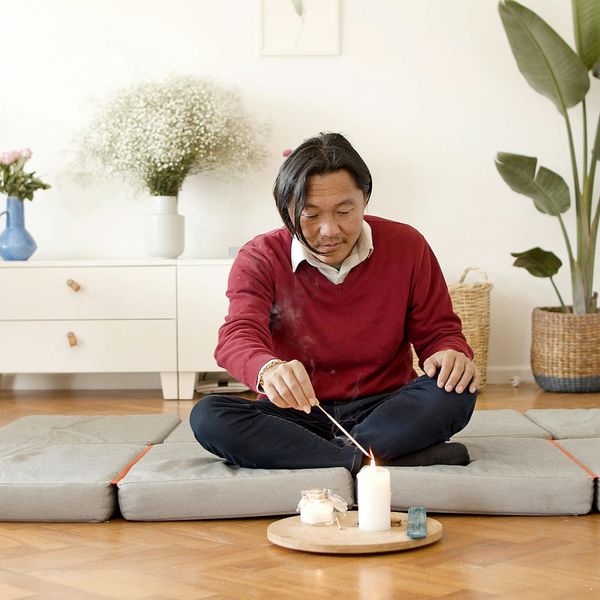 Minimalist meditation space with incense and wooden floors